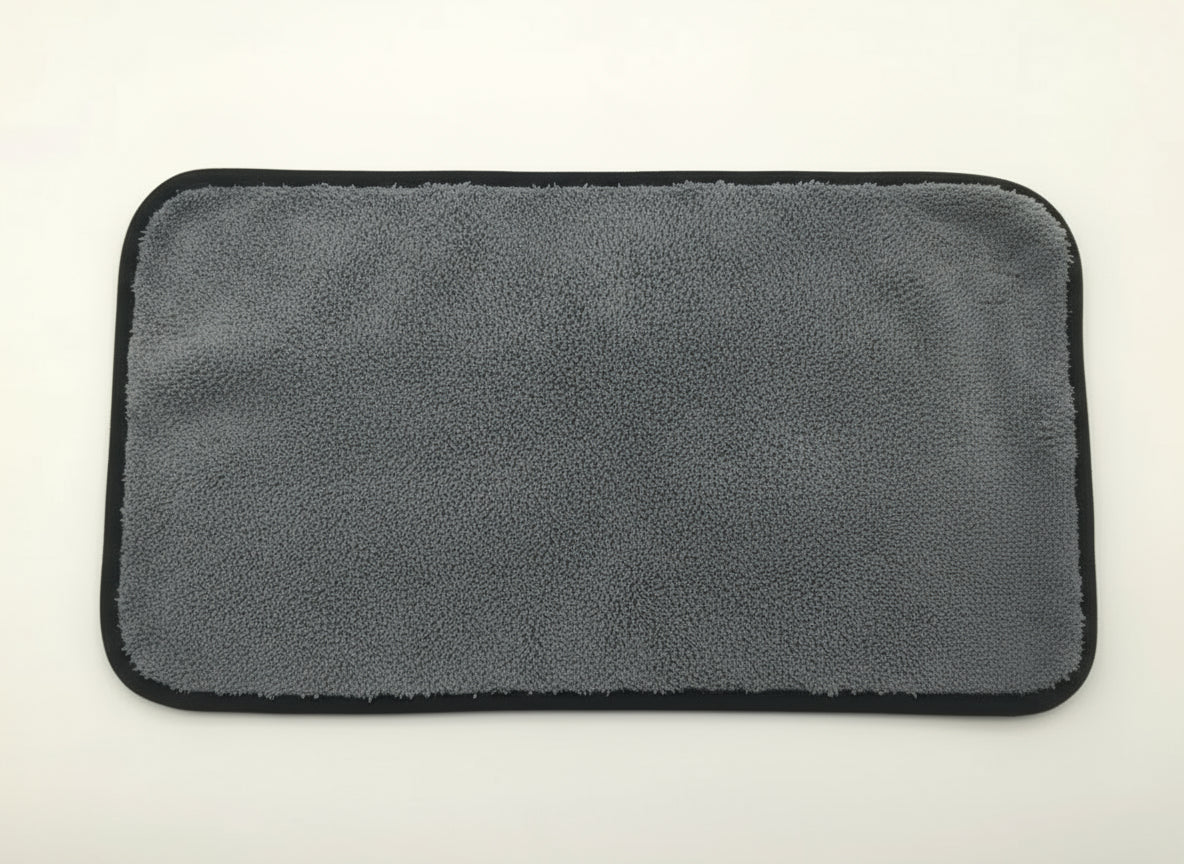 Gray microfiber towel with a yellow corner on a white background