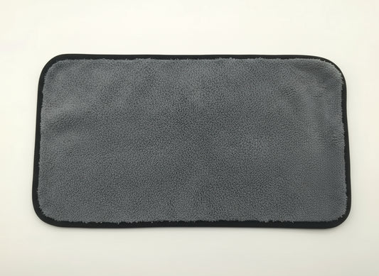 Gray microfiber towel with a yellow corner on a white background