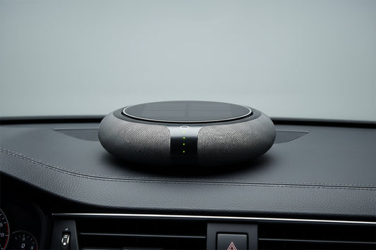 Round black device with solar panel on a white background